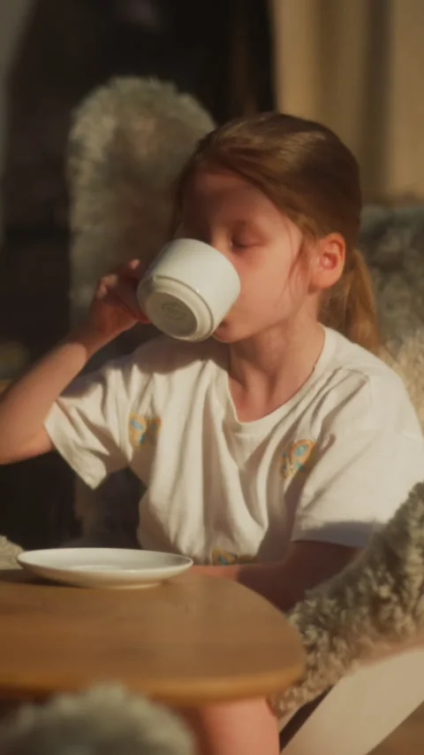Kids have breakfast sitting at table in cozy dining room Stock Footage 303224080