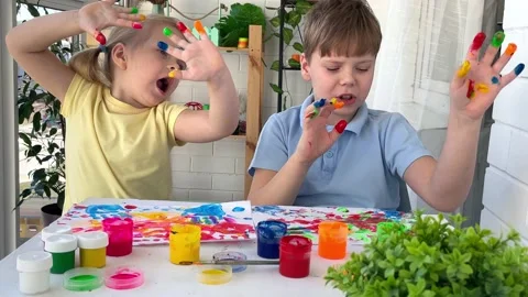 Kids have fun and create picture. Palms of different colors. Stock Footage 237824339
