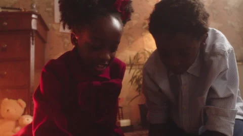 Kids have fun playing marbles together in cozy living room Stock Footage 319908487