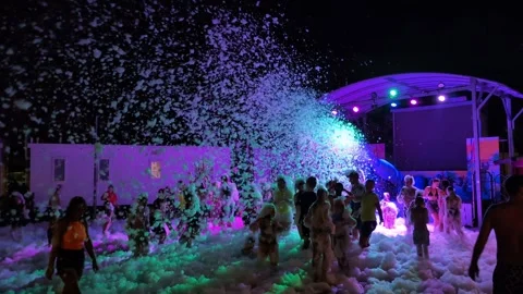 Kids having a foam party, dancing in soap bubbles . Stock Footage 320941826