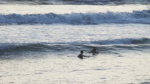 Kids having fun in ocean waves Stock Footage 83699582