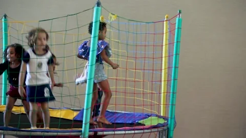 Kids having fun, playing and jumping on a trampoline Stock Footage 148699257
