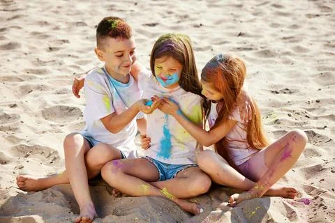 Kids having fun by playing with colored powder Stock Photos