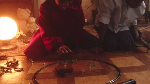 Kids having fun playing marbles indoors at home during evening time Stock Footage 319908136