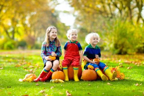 Kids having fun at pumpkin patch Photos