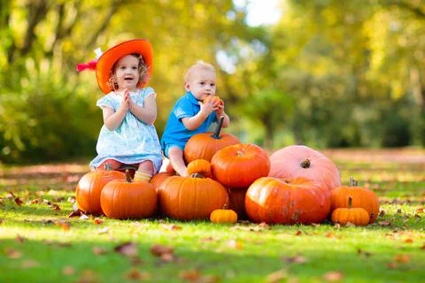 Kids having fun at pumpkin patch Stock Photos