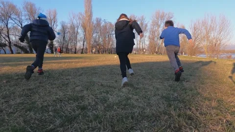 Kids having fun running on meadowslow motion Stock Footage 278945066