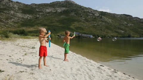 Kids having fun with soap bubbles Stock Footage