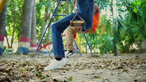 Kids having fun on a swing set Stock Footage 312690756