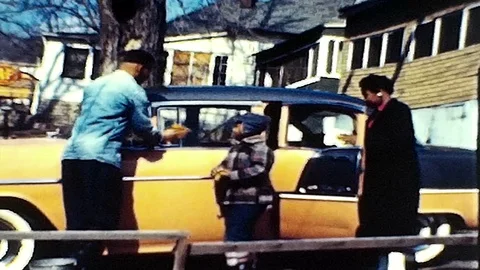 The kids help dad clean the family car 1950s vintage film home movie 4834 Stock Footage