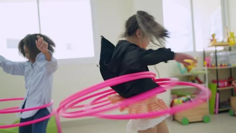 Kids hula hooping in playroom Stock Footage 337159096