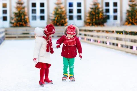 Kids ice skating in winter. Ice skates for child. Stock Photos