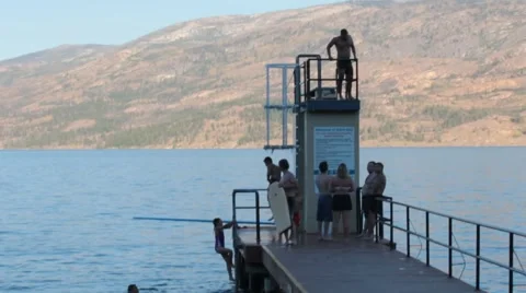 Kids jumping off dock Stock Footage 40301124