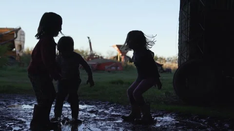 Kids jumping in the mud Stock Footage 240139592