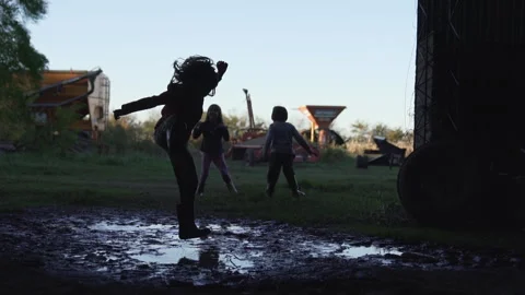 Kids jumping in the mud Stock Footage 240139679