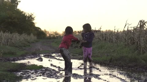 Kids jumping in the mud Stock Footage 240141201