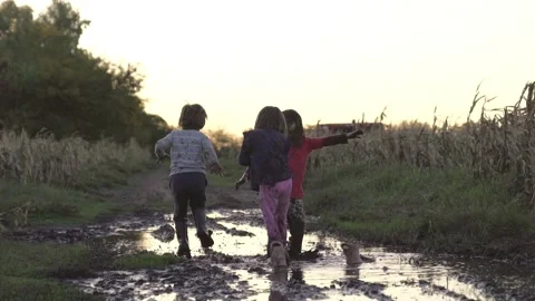 Kids jumping in the mud Stock Footage 240141229