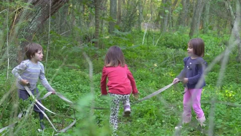 Kids jumping rope in the forest. Stock Footage 240574058