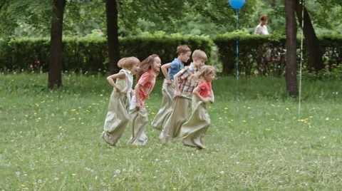 Kids Jumping in Sacks Stock Footage