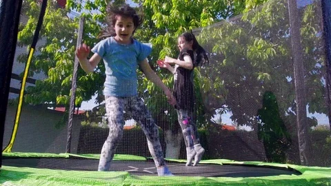Kids jumping on trampoline, slow motion - 01 Stock Footage 107680461