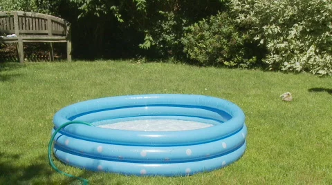Kids jumping in wading pool slo mo Stock Footage