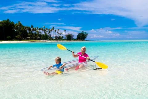Kids kayaking in ocean. Family in kayak in tropical sea Stock Photos