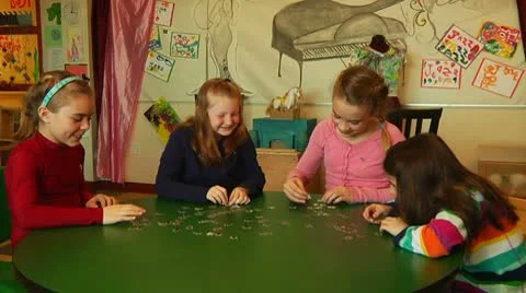 Kids laughing while they play with puzzle Stock Footage 8916096