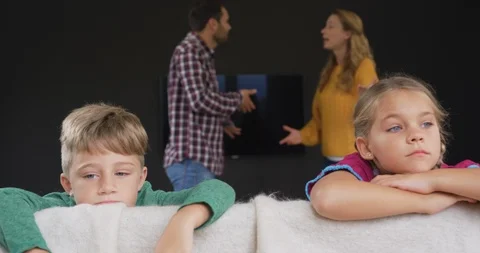 Kids leaning on sofa while parents arguing in background at home 4k Stock Footage 112039732