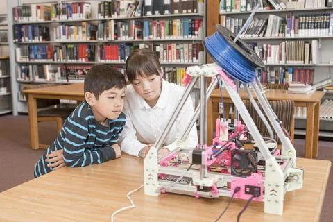 Kids learn about the 3D printer. Stock Photos