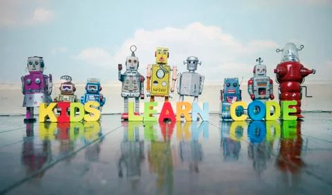 KIDS LEARN CODE robots on a wooden floor Stock Photos