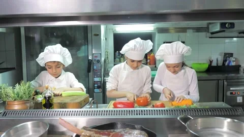 Kids learning how to cook eggs in a cooking class in restaurant kitchen Stock Footage 150312676