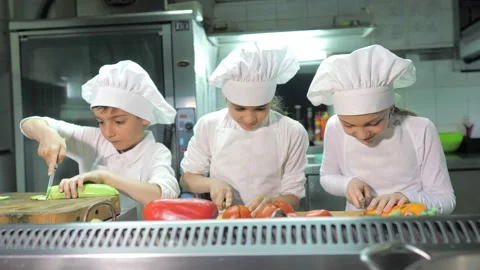 Kids learning how to cook eggs in a cooking class in restaurant kitchen Stock Footage 150312783