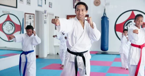 Kids, learning karate and training with instructor for fight, fitness or self Stock Footage 307380593