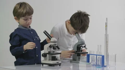 Kids learning to use microscope in the s... | Stock Video | Pond5