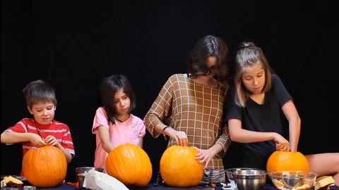Kids Looking Miserable Carving Pumpkins Video stock 97598109