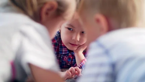 Kids Lying on Bed and Playing on Tablet Видео 101042391