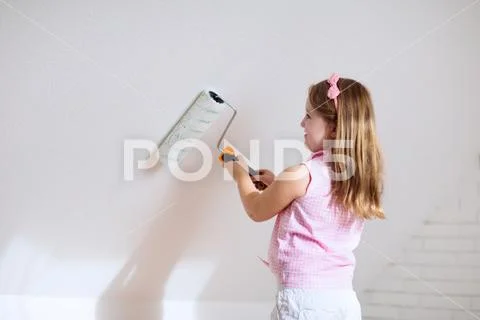Kids painting attic wall. Home improvement. Stock Photos