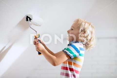 Kids painting attic wall. Home improvement. Stock Photos