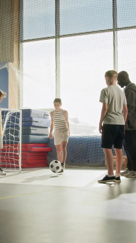 Kids Passing Ball in Circle Doing Soccer Drills in Indoor Gym Vertical Stock Footage 327066683