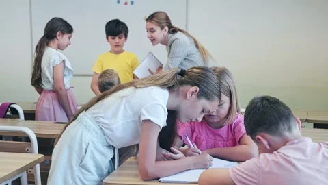 Kids performing group tasks during lesso... | Stock Video | Pond5