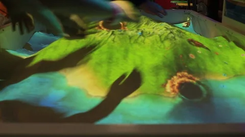 Kids play with interactive, virtual sand Stock Footage 123698609