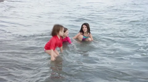 Kids Play in Waves Stock Footage 58837577