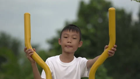 Kids playing and exercing on public outdoor gym park Stock Footage 135546435