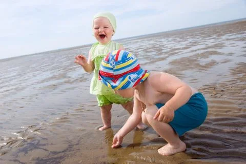 Kids playing at the beach Stock Photos