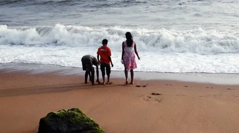 Kids playing at beach with soft tide Видео 52823959