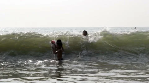 Kids Playing in Breaking Ocean Waves Stock Footage 58827100
