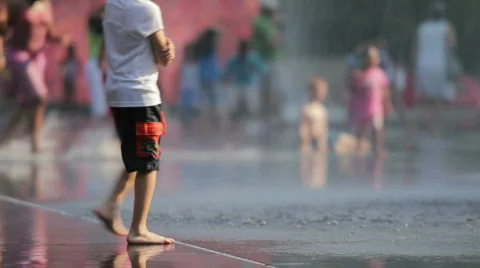 Kids playing in a city fountain Stock Footage