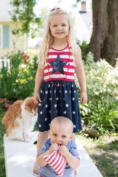 Kids playing cornhole in backyard on Fourth of July Stock Photos