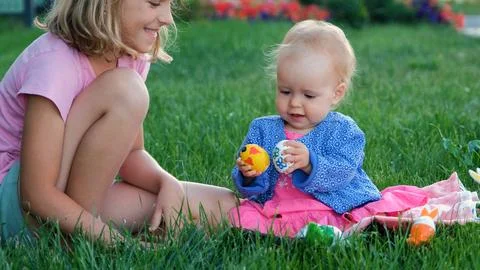 Kids playing with Easter eggs on grass Foto stock
