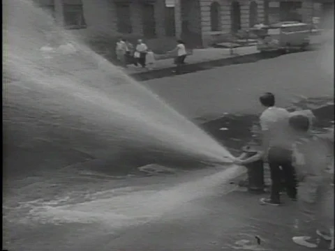Kids playing with Fire Hydrant NYC Hot Summer Day 1960s New York City Stock Footage